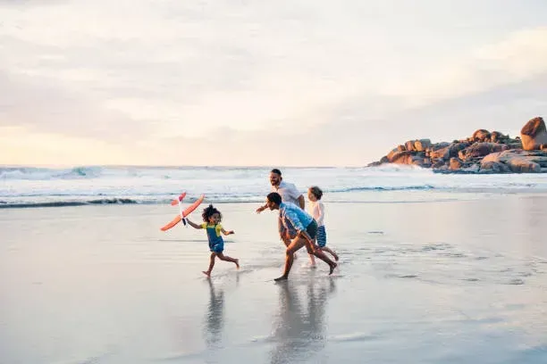 Evaheld Young family flying a kite on the beach at dusk featured image for how-discuss-end-of-life-wishes